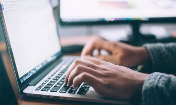 Hands typing on laptop, Photo by Glenn Carstens-Peters on Unsplash